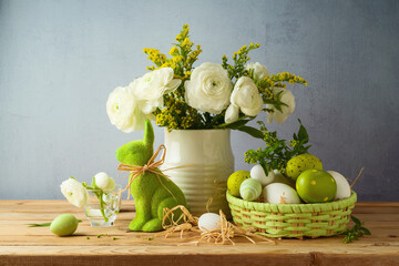 Easter holiday concept with beautiful flowers bouquet and Easter eggs on wooden table