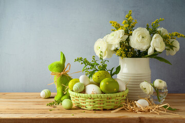 Easter holiday concept with beautiful flowers bouquet and Easter eggs on wooden table