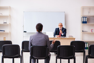 Two businessmen in the classroom in pandemic concept