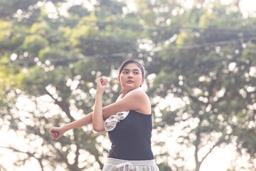 Asian woman so happy and jogging and workout foe health in the park.Sport and health concept.