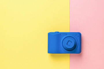 The camera is in a stylish blue color on a two-tone background.