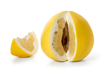 Large ripe pomelo fruit with a carved piece on a white background. Full depth of field. With clipping path