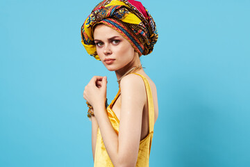 woman in yellow dress multicolored turban on her head decoration studio lifestyle glamor