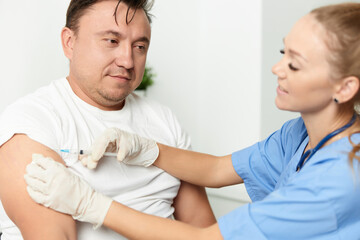 Fototapeta premium female doctor holding an injection to a patient vaccination