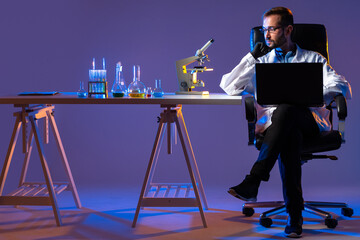 Man sits laboratory table. Laboratory testing performed on component. Laboratory testing components...