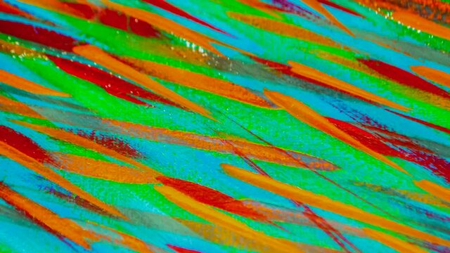 Many different colored lines painted bright paint on canvas close-up. Green, orange, red, blue colors. Brush strokes on canva. Cracks, scratches. Abstract grunge multicolored creativity art background