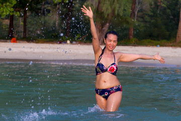 Woman in bikini sexy with play water