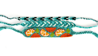 Woven DIY friendship bracelets handmade of embroidery floss with knots in blue colors
