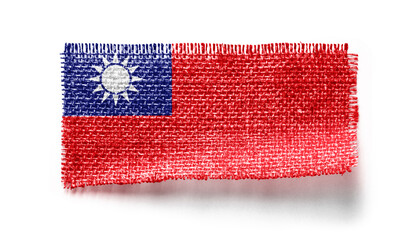 Taiwan flag on a piece of cloth on a white background