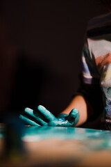 Young boy painting with colorful hands. Creativity and art , painting concept