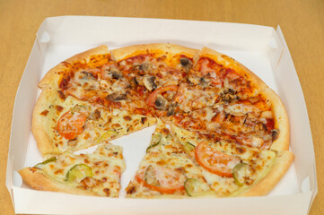 Pizza in a box on the table.