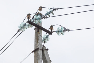 Supports of power lines. Power lines and posts. Detailed close-up.