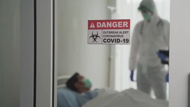 Doctor and nurse prepare vaccine shot for injection to asian patient.