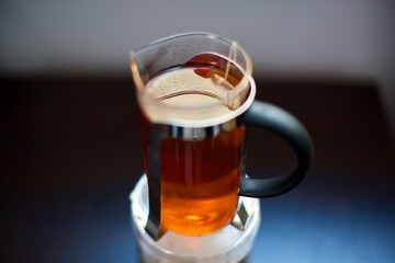 glass of fresh tea bags on black blurry background