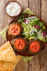 Pakistani Chapli Kebab closeup in the pan on the table. Vertical top view from above