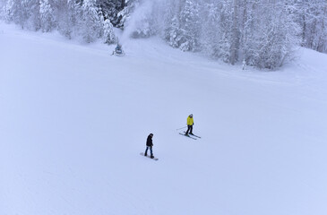 Downhill skier. Snowboarders and skier ride on snow in the mountains. Downhill ride. Adventure...