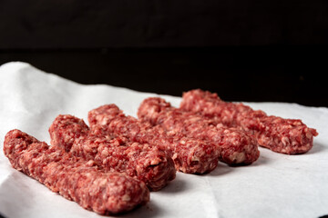 minced meat on white paper on dark background
