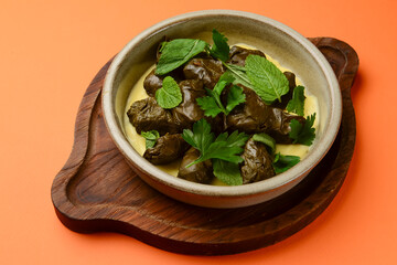 Piping hot baked cabbage rolls with sauce ready to serve. Traditional Georgian cuisine concept.