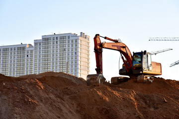 Excavator on earthworks at construction site. Backhoe on foundation work and road construction....