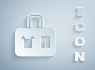 Paper cut Suitcase for travel icon isolated on grey background. Traveling baggage sign. Travel luggage icon. Paper art style. Vector.