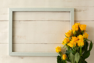 bouquet of yellow rose and wooden frame