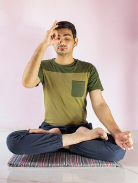 A young indian shredded teenage boy doing yoga aasan in the home. anulom Vilom pose.