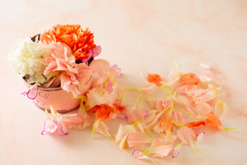 colorful carnation petal in a pink bucket and on the floor.