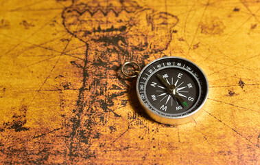 Compass on map. Tourist compass for orientation on the terrain. Magnetic declination сalculator. Historical explorer help. Map reading and land navigation concept. Orient on maps