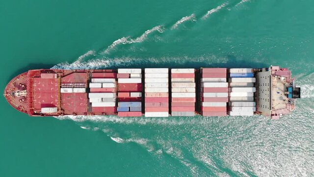 Aerial top view of cargo maritime ship contrail in the ocean ship carrying container and running export from international port to custom ocean concept freight shipping by ship smart service forward 