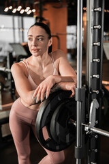 Fototapeta na wymiar Young beautiful caucasian fit strong woman is doing exercises in gym