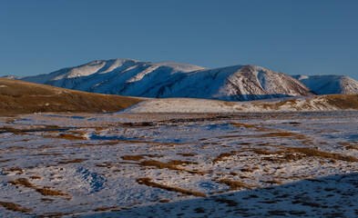 Russia. The South Of Western Siberia, The Altai Mountains. Desert mountains covered with the first snow on the road to the Jazator River near the village of Kosh-Agach.
