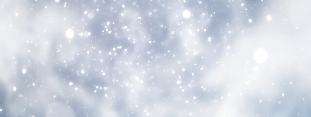 Fototapeta premium blue snowfall bokeh background, abstract snowflake background on blurred abstract blue