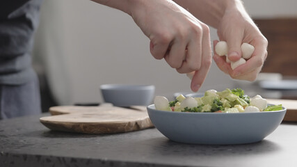 man make salad with kale, mozzarella, avocado and cherry tomatoes, add mozzarella