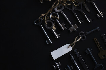 Set of vintage keys for a lock. Retro keys on a dark stone background. The concept of choosing the...