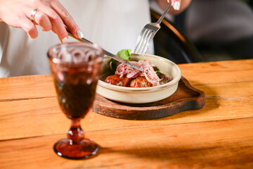 Dinner at Georgian restaurant. Eating out concept, eating BBQ fiery sausages with vegetables.