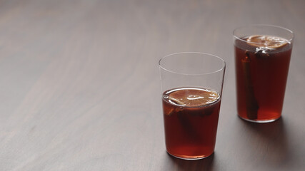 mulled wine in thin tumbler glasses on walnut table