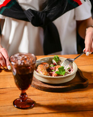 Dinner at Georgian restaurant. Eating out concept, eating BBQ fiery sausages with vegetables.