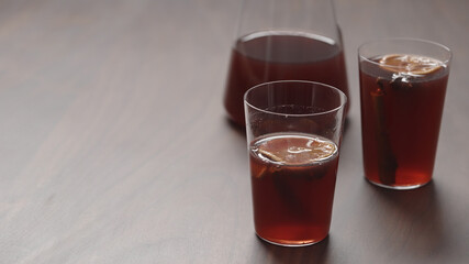 mulled wine in thin tumbler glasses on walnut table