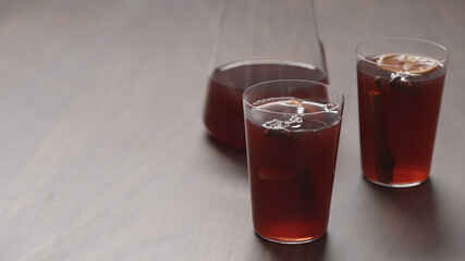 mulled wine in thin tumbler glasses on walnut table