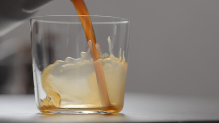 pour coffee in tumbler glass on concrete countertop with copy space