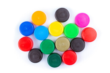 Group of multi colored bottle caps on a white background. Recycling and reuse concept. Space for text.