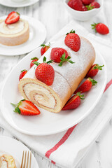 Tasty roll cake stuffed with cream cheese ,decorated with fresh strawberry