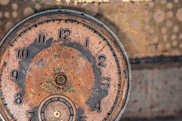 Vintage grunge background of an old clock. Abstract texture covered with dust, dirt, scratches. Macro photography in light tinted