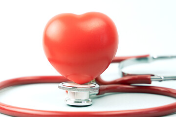 Red heart with stethoscope on white background