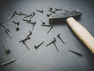 Old rusty nails and a hammer, repair tools.