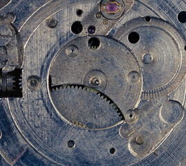Vintage watch movement close - up. Selective focus on elements, macro photography. Background in steampunk style. Metallic grunge texture. Easy image tinting