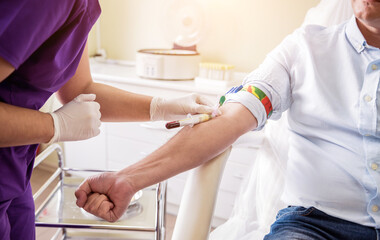 Nurse taking a patient's blood sample at lab