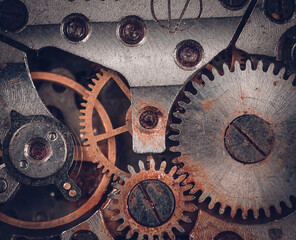 Vintage watch movement close - up. Selective focus on elements, macro photography. Background in steampunk style. Metallic grunge texture. Easy image tinting