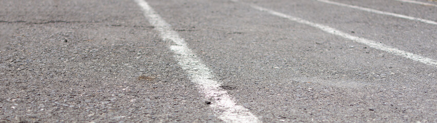Old asphalt running track. Worn-out road surface