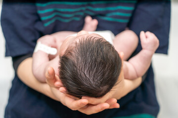 Head of a baby being held by its mother_06
